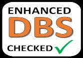 Enhanced DBS checked badge with orange letters, black text, green checkmark on white background, symbolizing verified electronics testing status